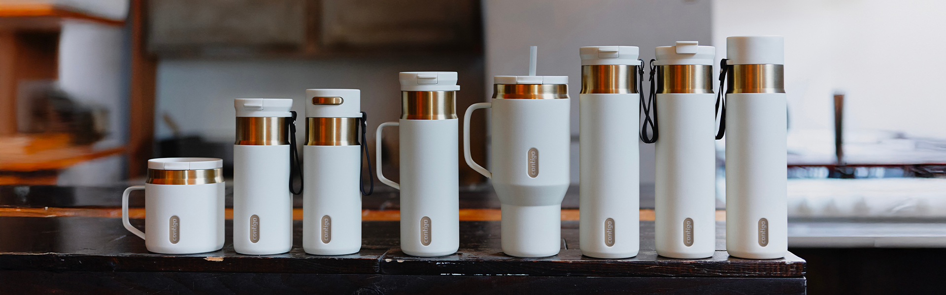A lineup of white Contigo mugs, bottles, and tumblers